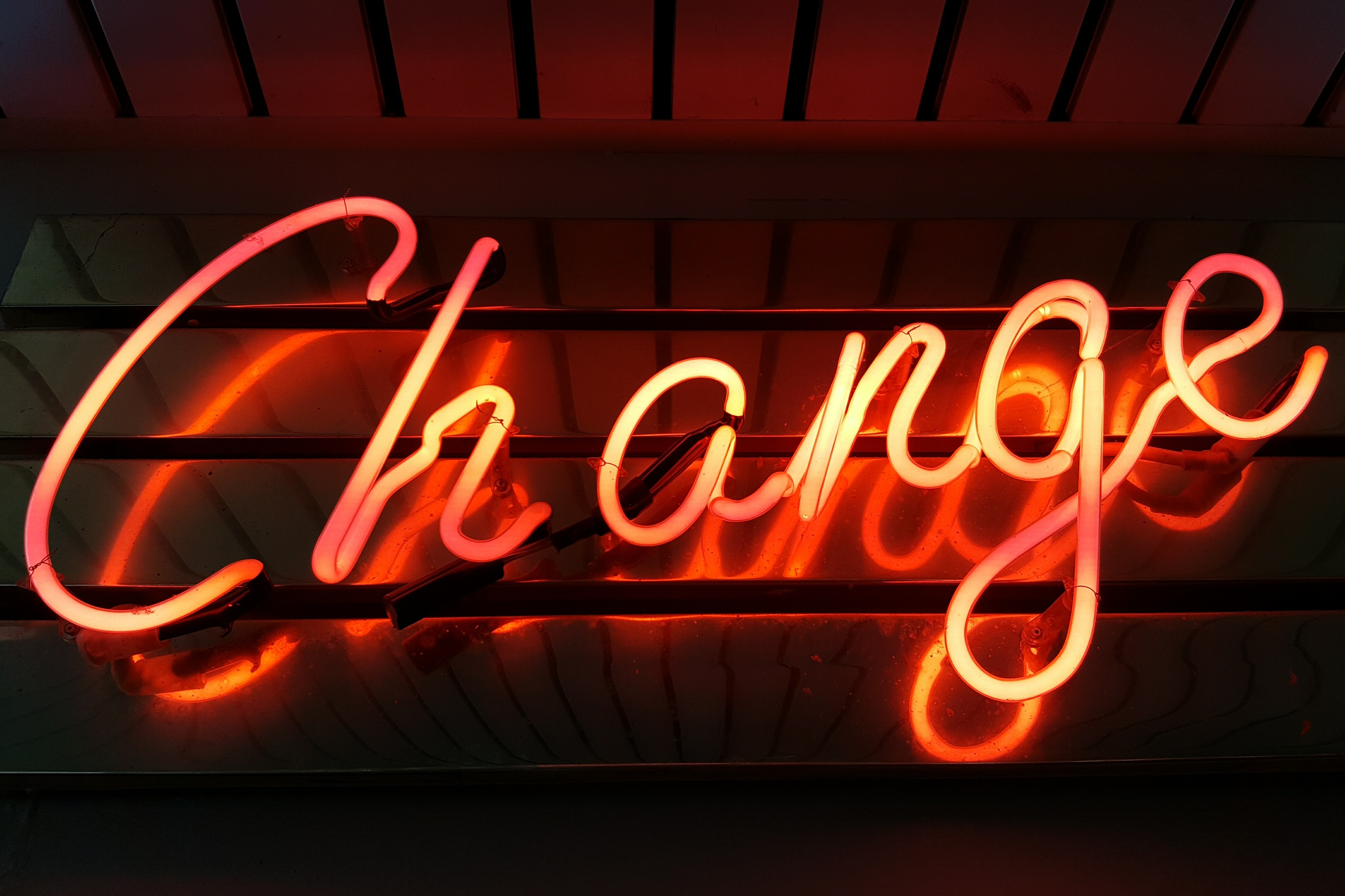 a neon sign lights up the word "Change"